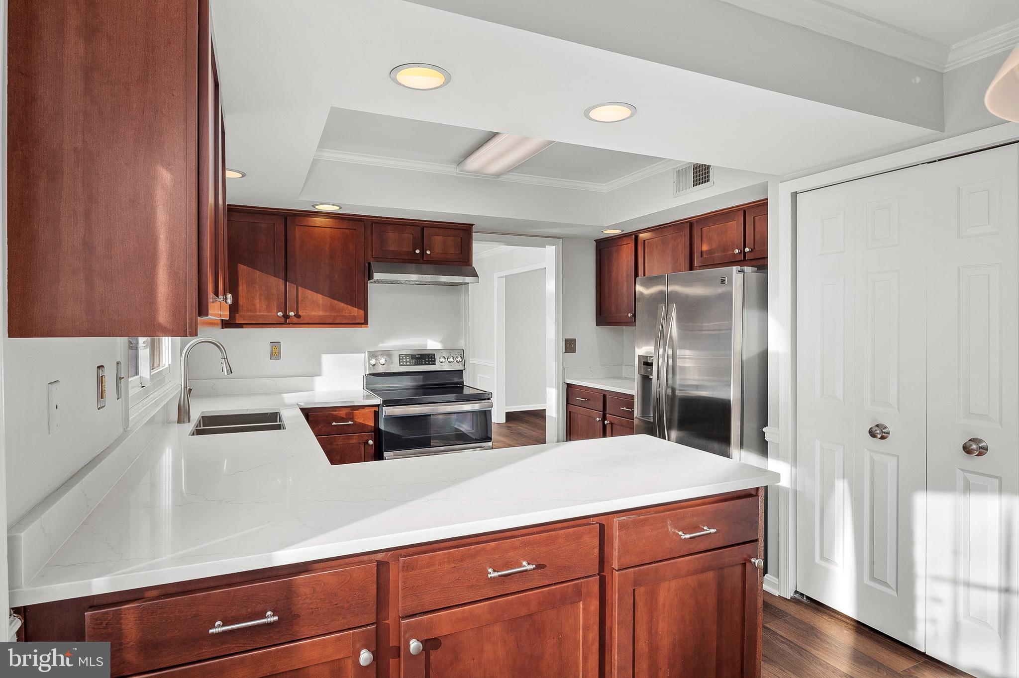 1508 Fairlakes Place Bowie, MD 20721 - Photo 11 of 51 a kitchen with stainless steel appliances a refrigerator sink and cabinets