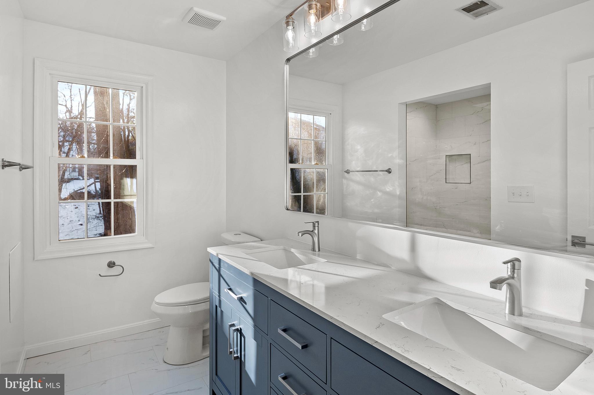 1508 Fairlakes Place Bowie, MD 20721 - Photo 31 of 51 a bathroom with a granite countertop sink a toilet and a mirror