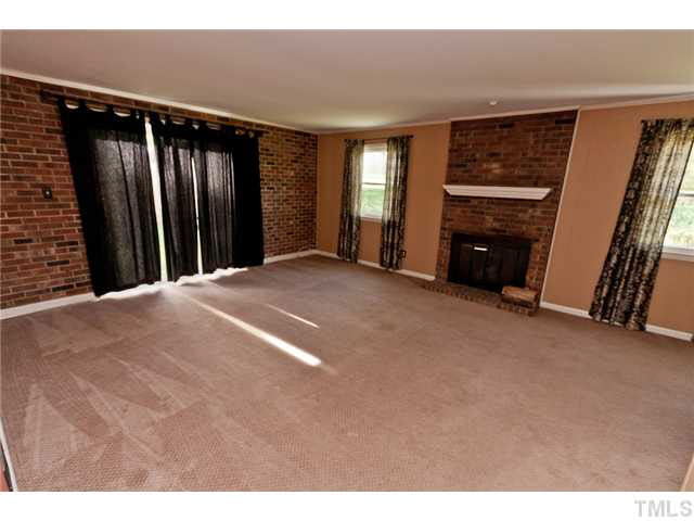 1530 Clermont Road Durham, NC 27713 - Photo 3 of 12 a view of an empty room with a fireplace and a window