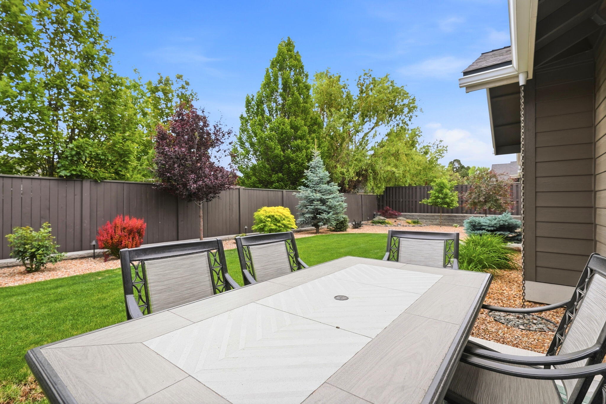 2714 Northwest 23rd Street Redmond, OR 97756 - Photo 42 of 57 a view of a chairs and table in the back yard