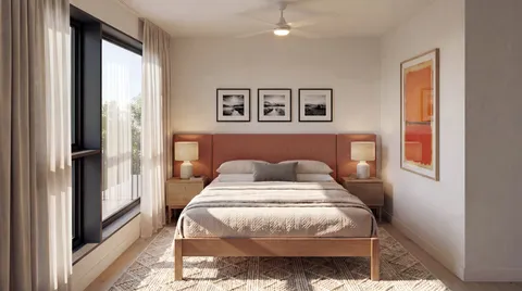 a bedroom with a large bed and a chandelier