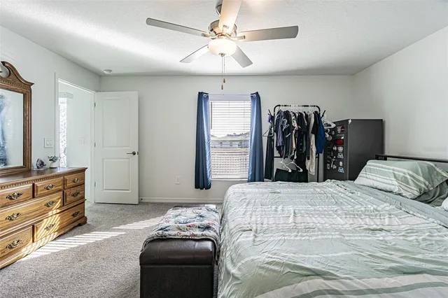 a bedroom with a bed and a dresser