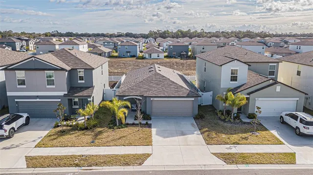 an aerial view of residential houses with outdoor space