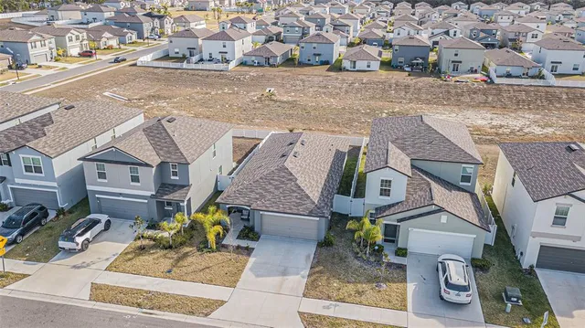 an aerial view of residential houses with outdoor space