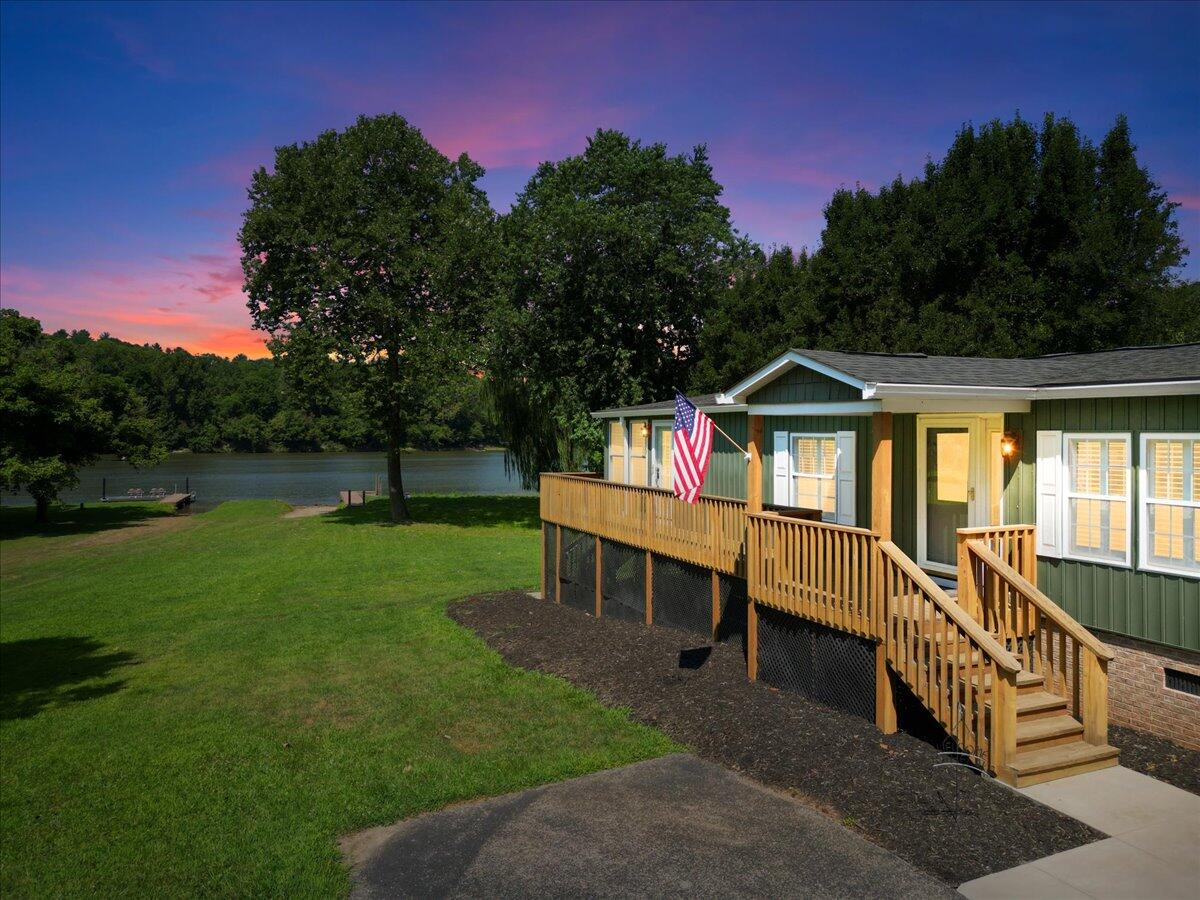 a view of an house with backyard space and deck