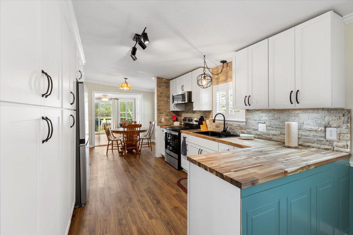 3729 Clark Road Hiwassee, VA 24347 - Photo 14 of 52 a kitchen with stainless steel appliances granite countertop a refrigerator a sink dishwasher a stove and white countertops with wooden floor