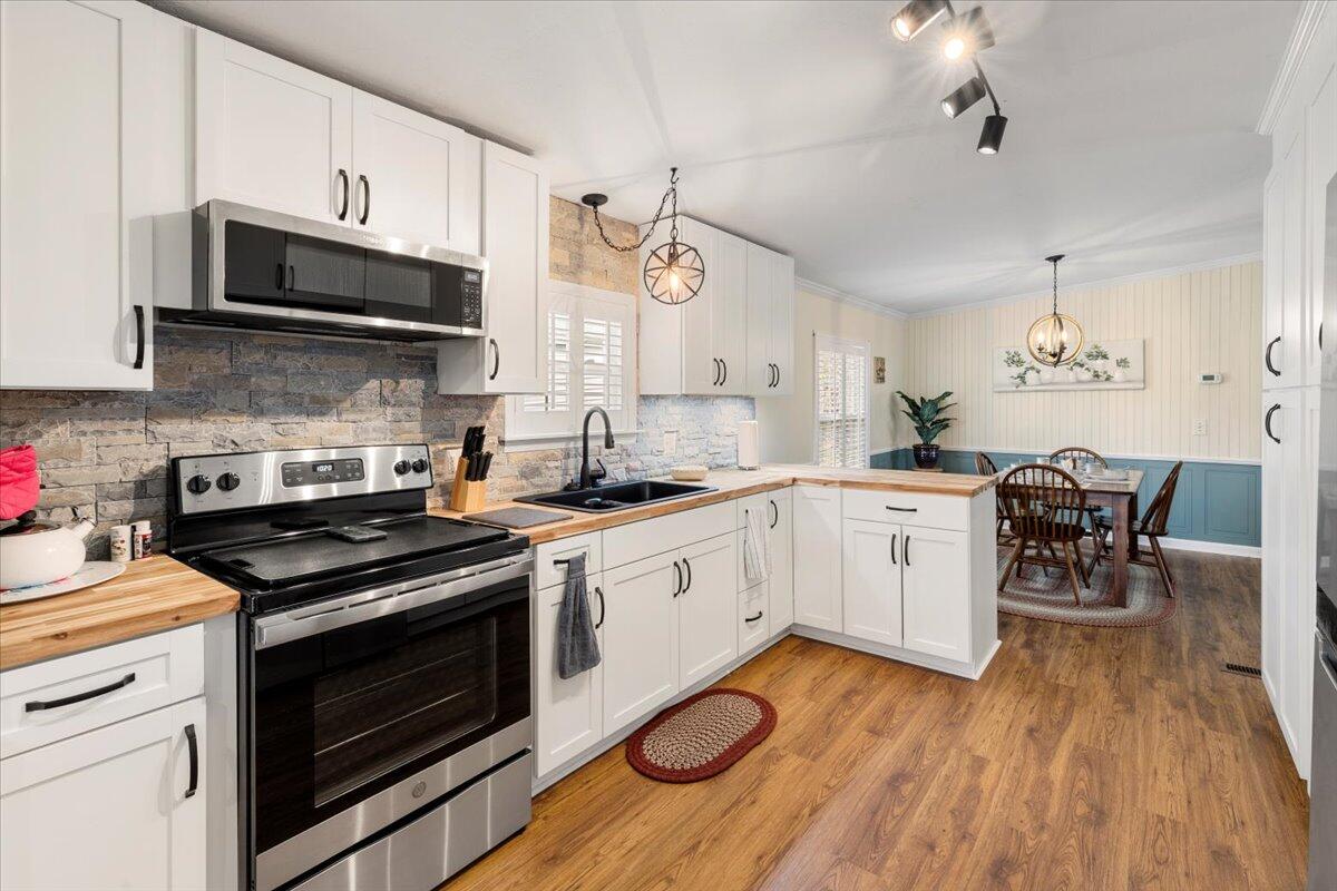 3729 Clark Road Hiwassee, VA 24347 - Photo 18 of 52 a kitchen with a stove a sink and a microwave