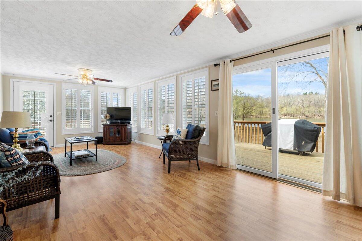 3729 Clark Road Hiwassee, VA 24347 - Photo 22 of 52 a living room with furniture and a flat screen tv with wooden floor