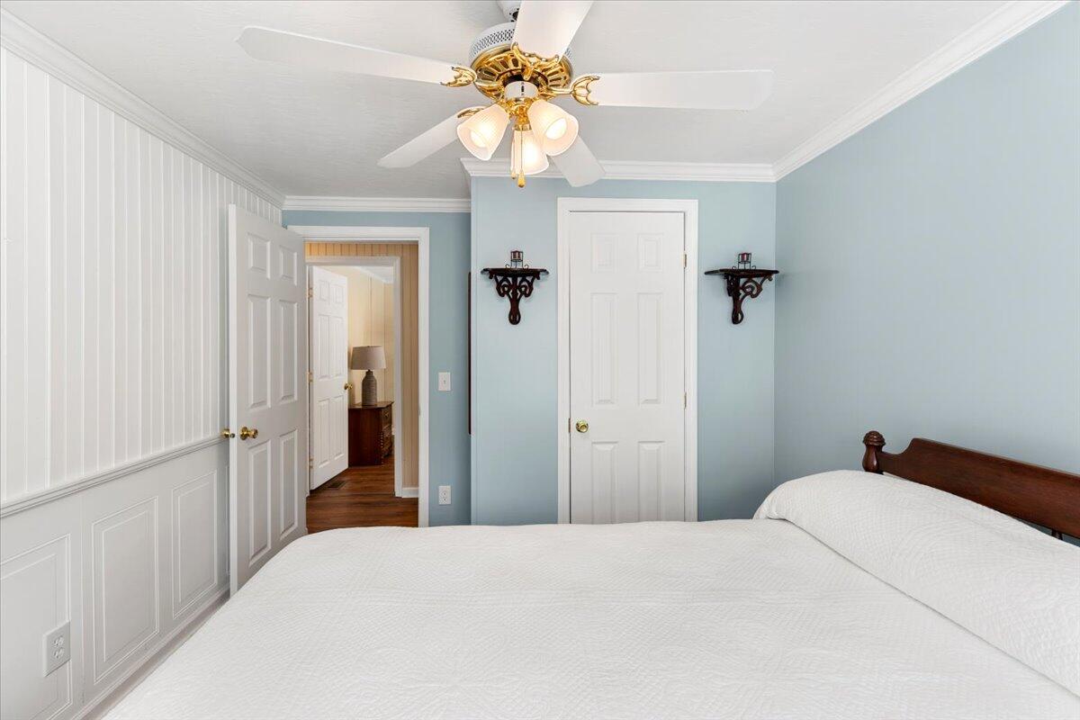 3729 Clark Road Hiwassee, VA 24347 - Photo 34 of 52 a bedroom with a bed and a chandelier