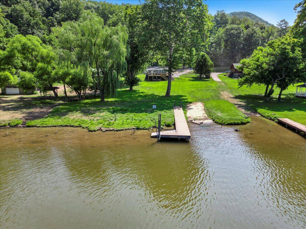 3729 Clark Road Hiwassee, VA 24347 - Photo 4 of 52 a view of a swimming pool with a garden and trees