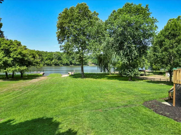 a view of a lake with houses in the back