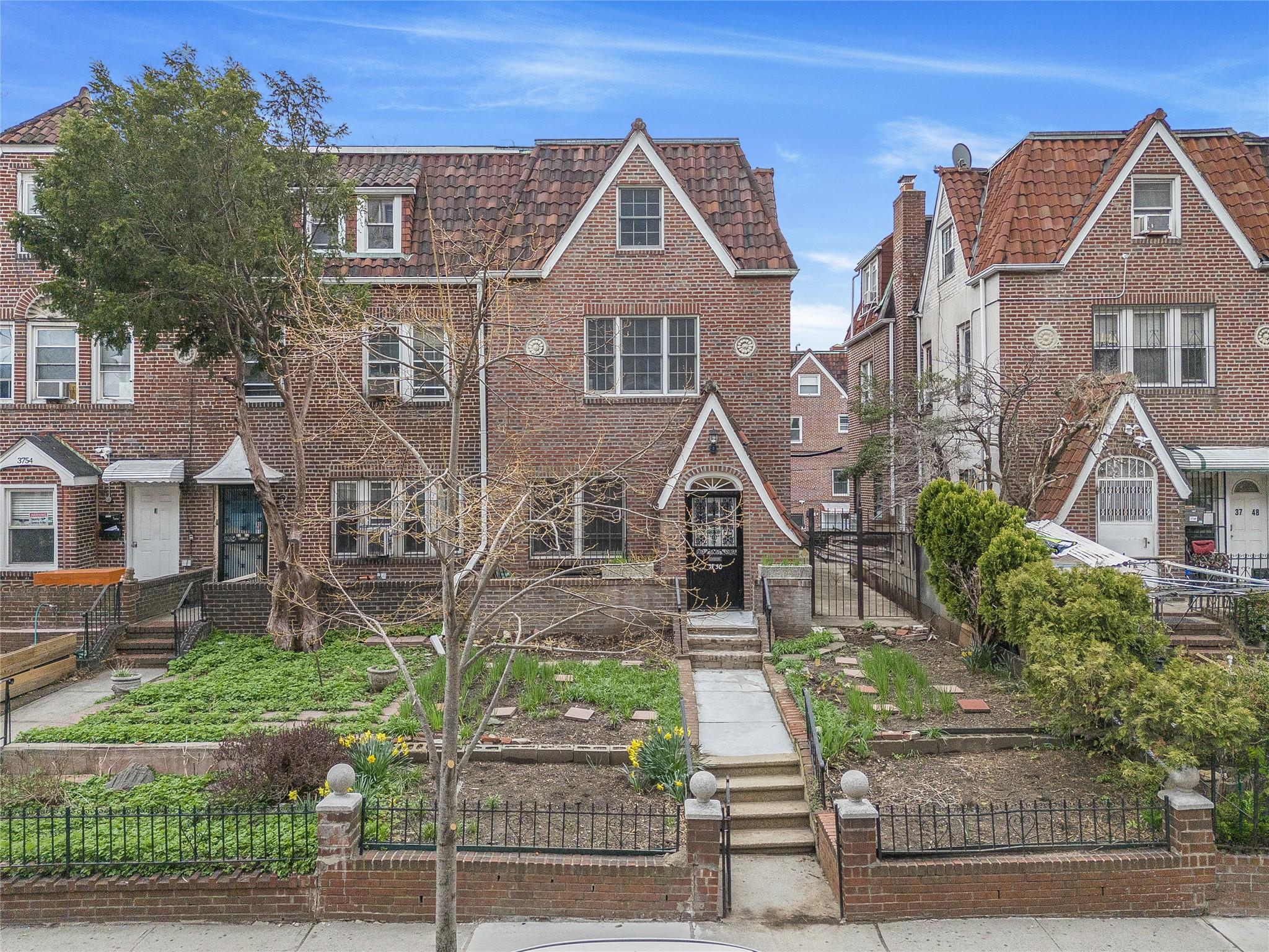 37-50 79th Street Queens, NY 11372 - Photo 1 of 1 front view of house with a yard