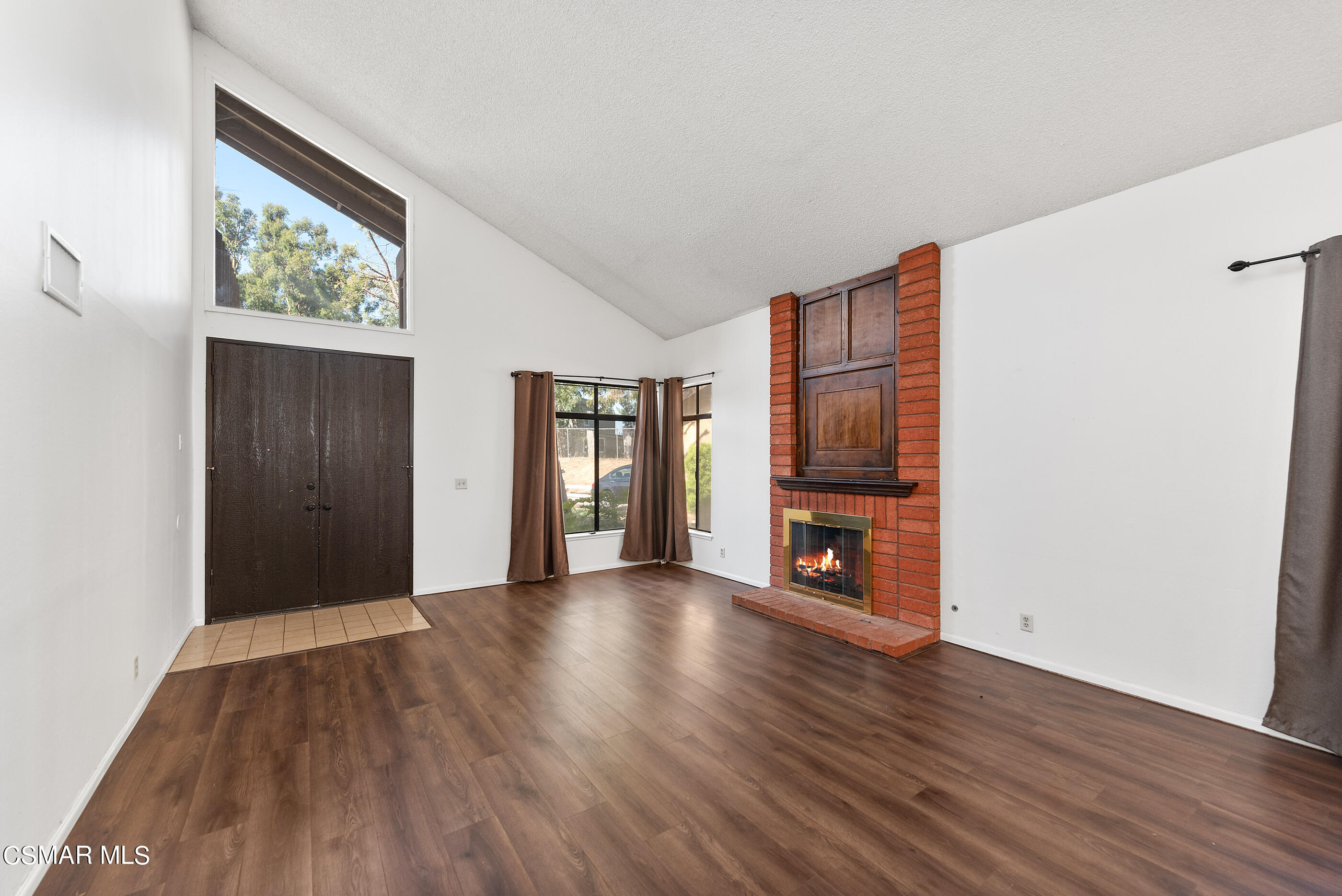 837 Hillview Circle Simi Valley, CA 93065 - Photo 5 of 42 an empty room with wooden floor fireplace and windows