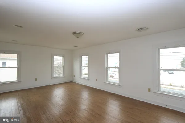 a living room with furniture a rug and white walls