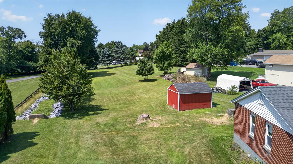 1166 Stones Crossing Road Easton, PA 18045 - Photo 21 of 35 A spacious, verdant yard unfolds with mature trees, offering a private setting for outdoor pursuits.