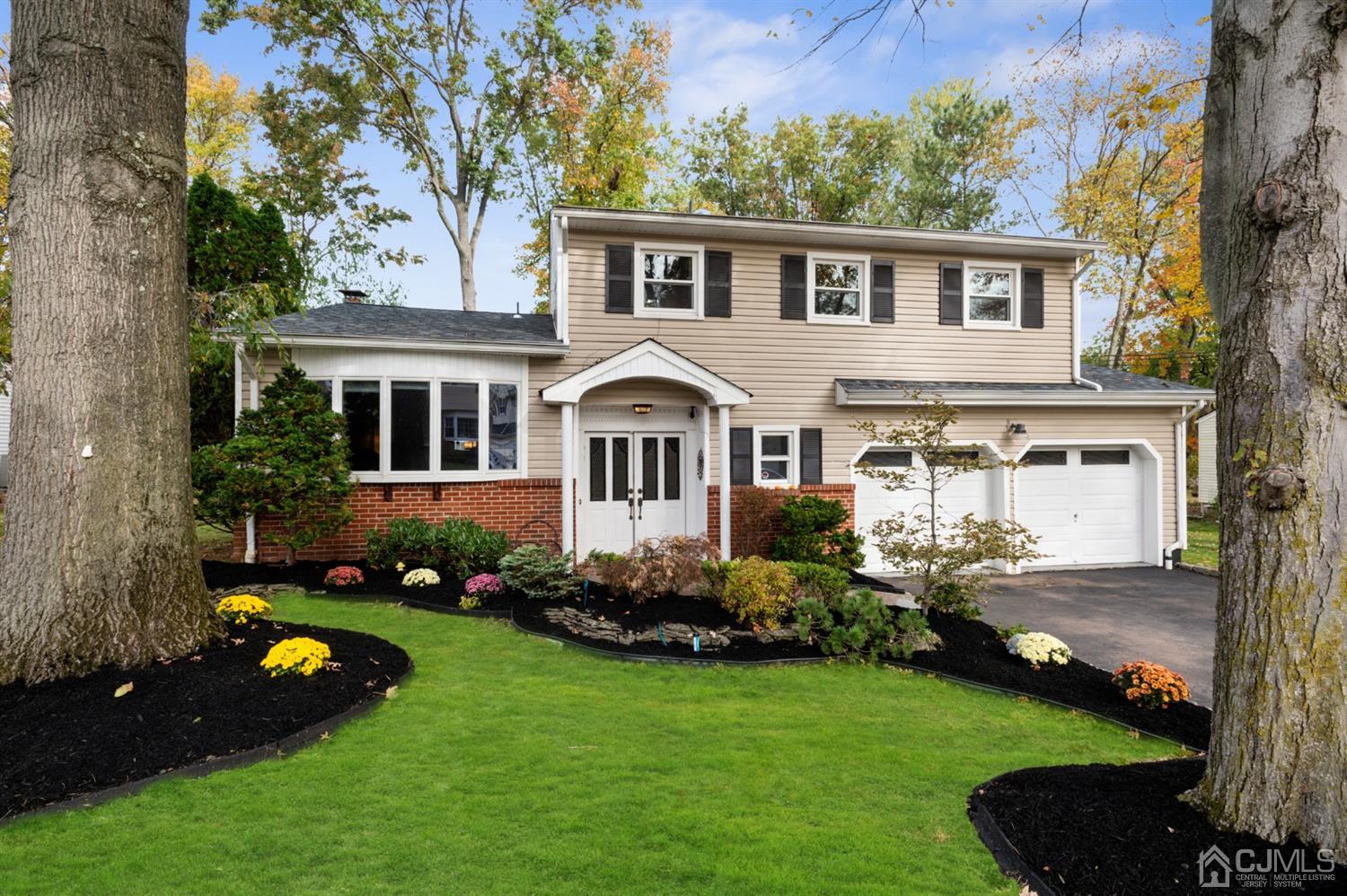 37 Lynnwood Road Edison, NJ 08820 - Photo 1 of 20 a front view of a house with a garden and trees