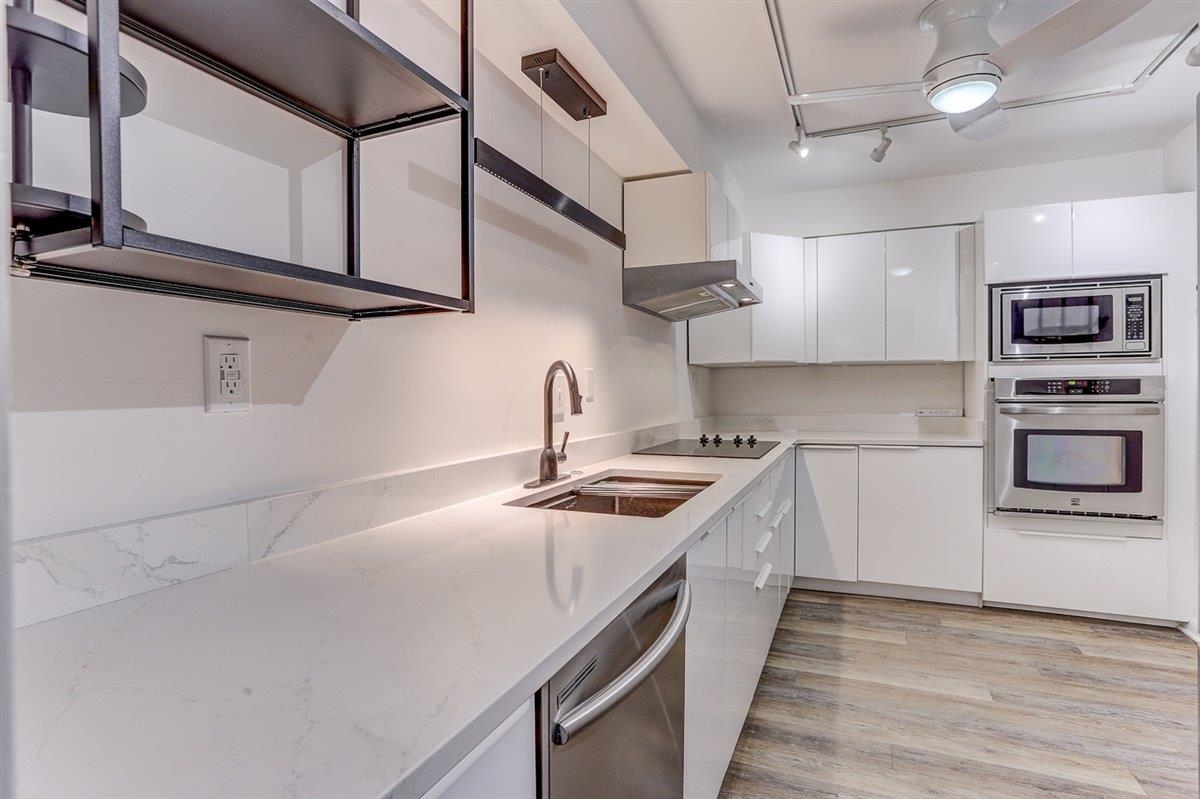 232 South Highland Street, Unit 409 Memphis, TN 38111 - Photo 13 of 39 a kitchen with stainless steel appliances granite countertop a sink and stove top oven