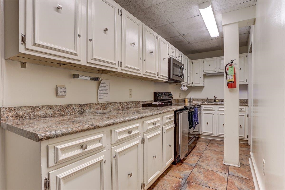232 South Highland Street, Unit 409 Memphis, TN 38111 - Photo 14 of 39 a kitchen with stainless steel appliances granite countertop a stove and a sink