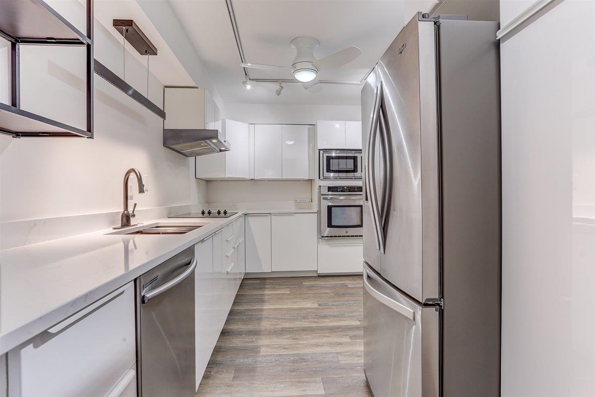 232 South Highland Street, Unit 409 Memphis, TN 38111 - Photo 15 of 39 a kitchen with stainless steel appliances granite countertop a refrigerator and a sink
