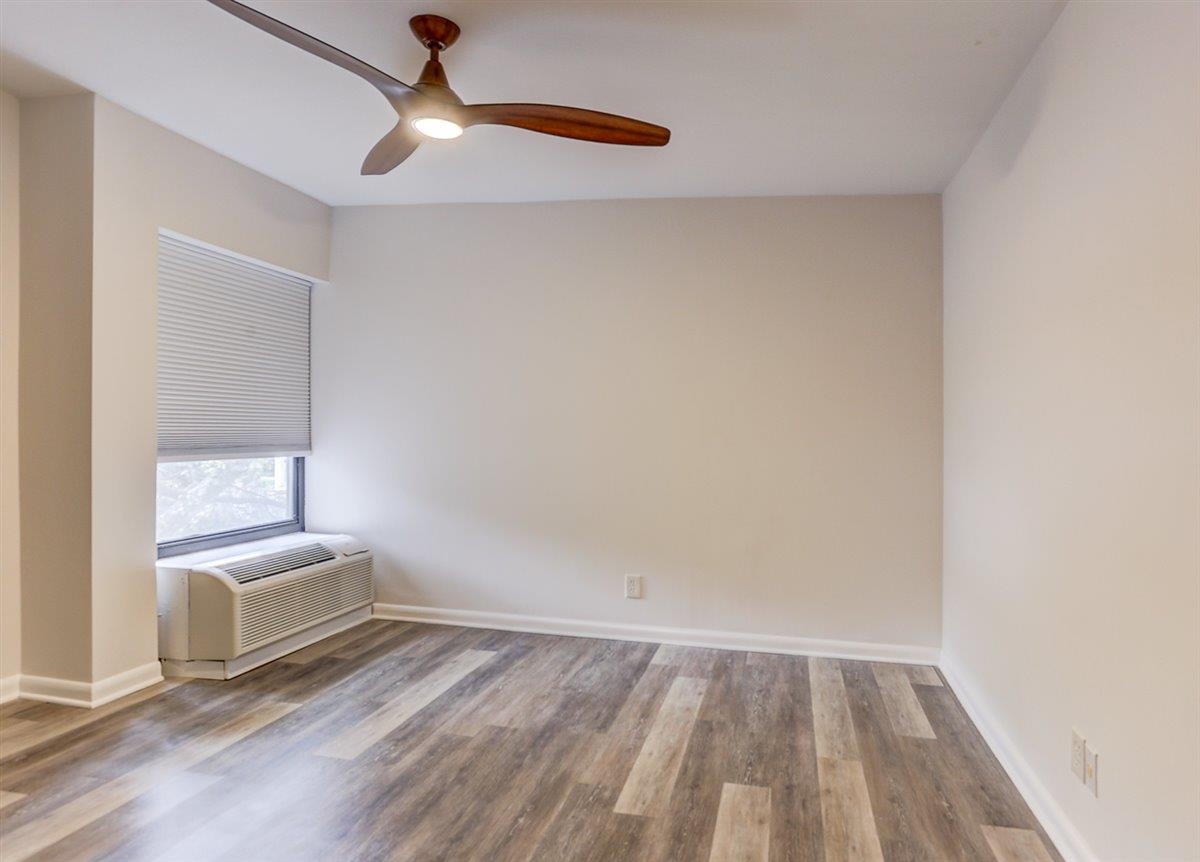 232 South Highland Street, Unit 409 Memphis, TN 38111 - Photo 25 of 39 a view of a room with wooden floor and a ceiling fan