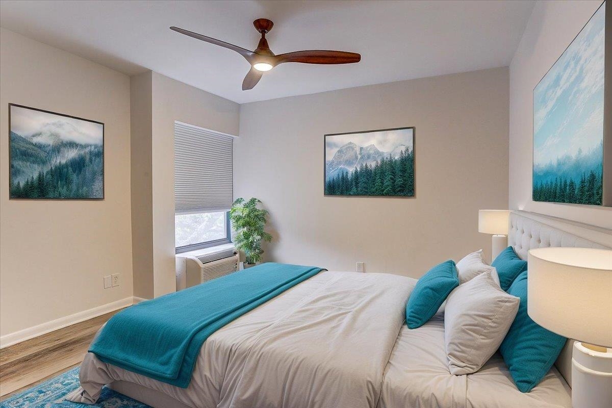 232 South Highland Street, Unit 409 Memphis, TN 38111 - Photo 26 of 39 a bedroom with a bed and a painting on the wall