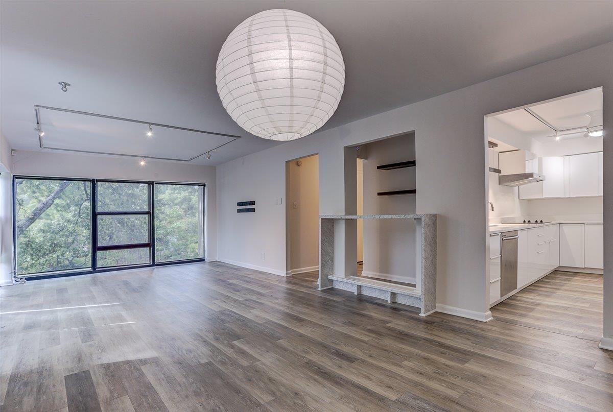 232 South Highland Street, Unit 409 Memphis, TN 38111 - Photo 5 of 39 an empty room with wooden floor and windows