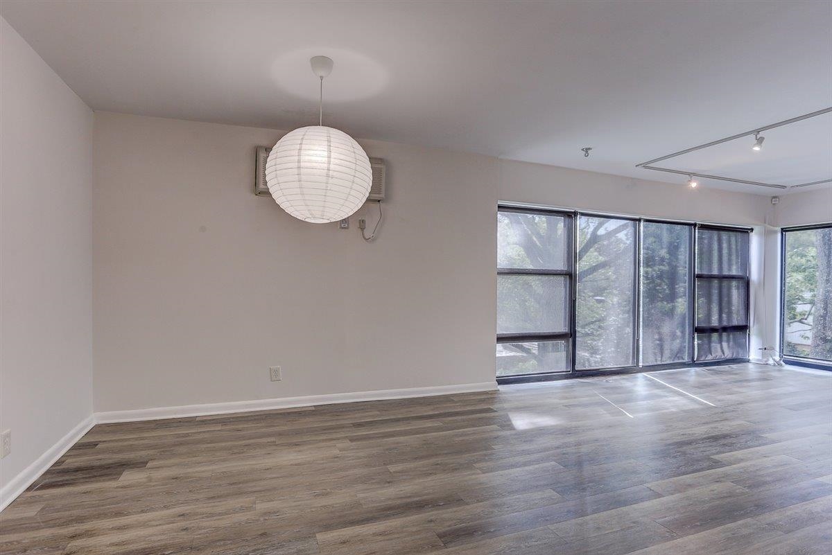 232 South Highland Street, Unit 409 Memphis, TN 38111 - Photo 6 of 39 an empty room with wooden floor and windows