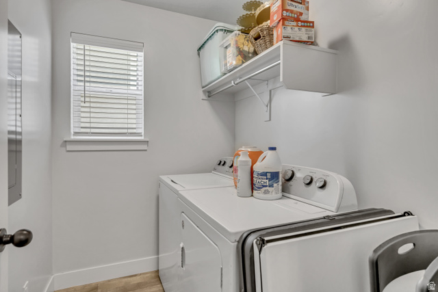 1577 Quailhill Road Saratoga Springs, UT 84045 - Photo 16 of 46 Laundry area featuring light wood-style floors and separate washer and dryer