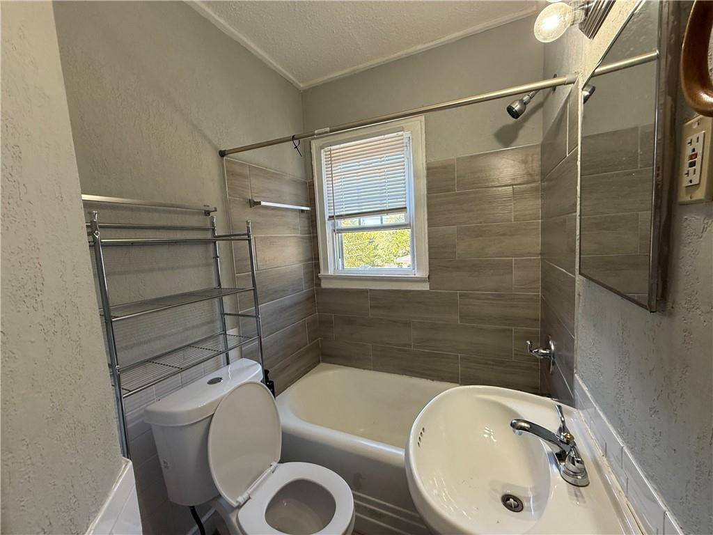 117 Vine Street Southwest, Unit B Atlanta, GA 30314 - Photo 11 of 22 a bathroom with a sink toilet and shower