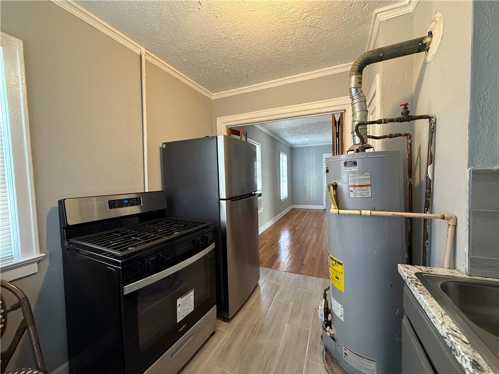 117 Vine Street Southwest, Unit B Atlanta, GA 30314 - Photo 13 of 22 a kitchen with stainless steel appliances granite countertop a refrigerator and a stove top oven