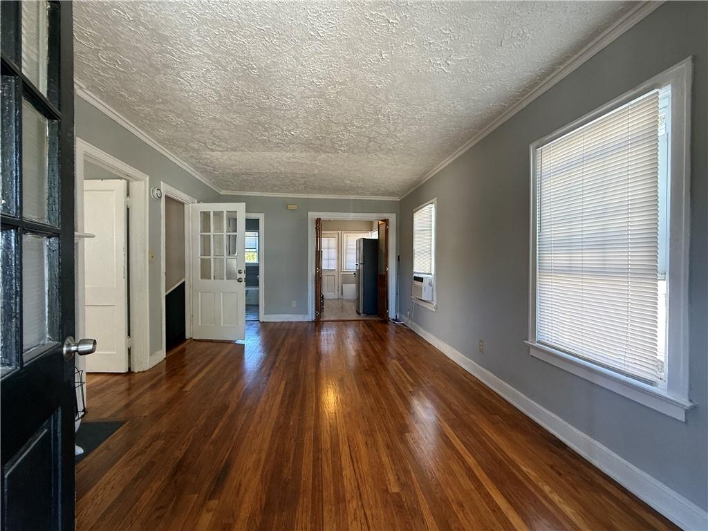 117 Vine Street Southwest, Unit B Atlanta, GA 30314 - Photo 5 of 22 a view of an empty room with wooden floor and a window