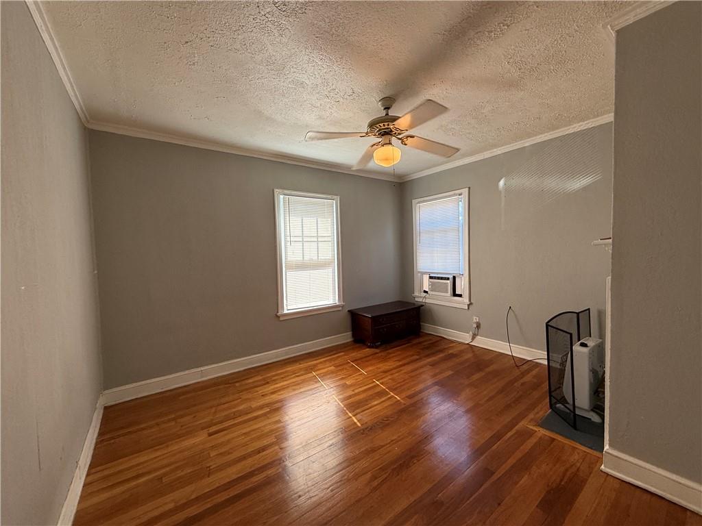 117 Vine Street Southwest, Unit B Atlanta, GA 30314 - Photo 8 of 22 a view of an empty room with a window and wooden floor
