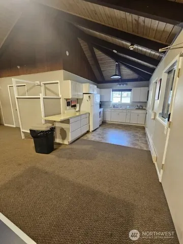 an empty room with furniture and a ceiling fan