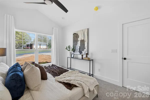 a bedroom with bed and a lamp