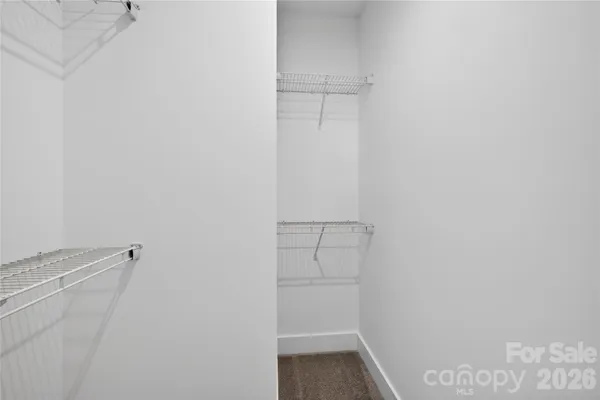 a view of a room with window and hardwood floor