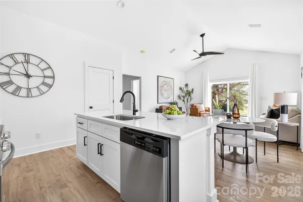 a kitchen with stainless steel appliances a stove a sink a microwave and cabinets