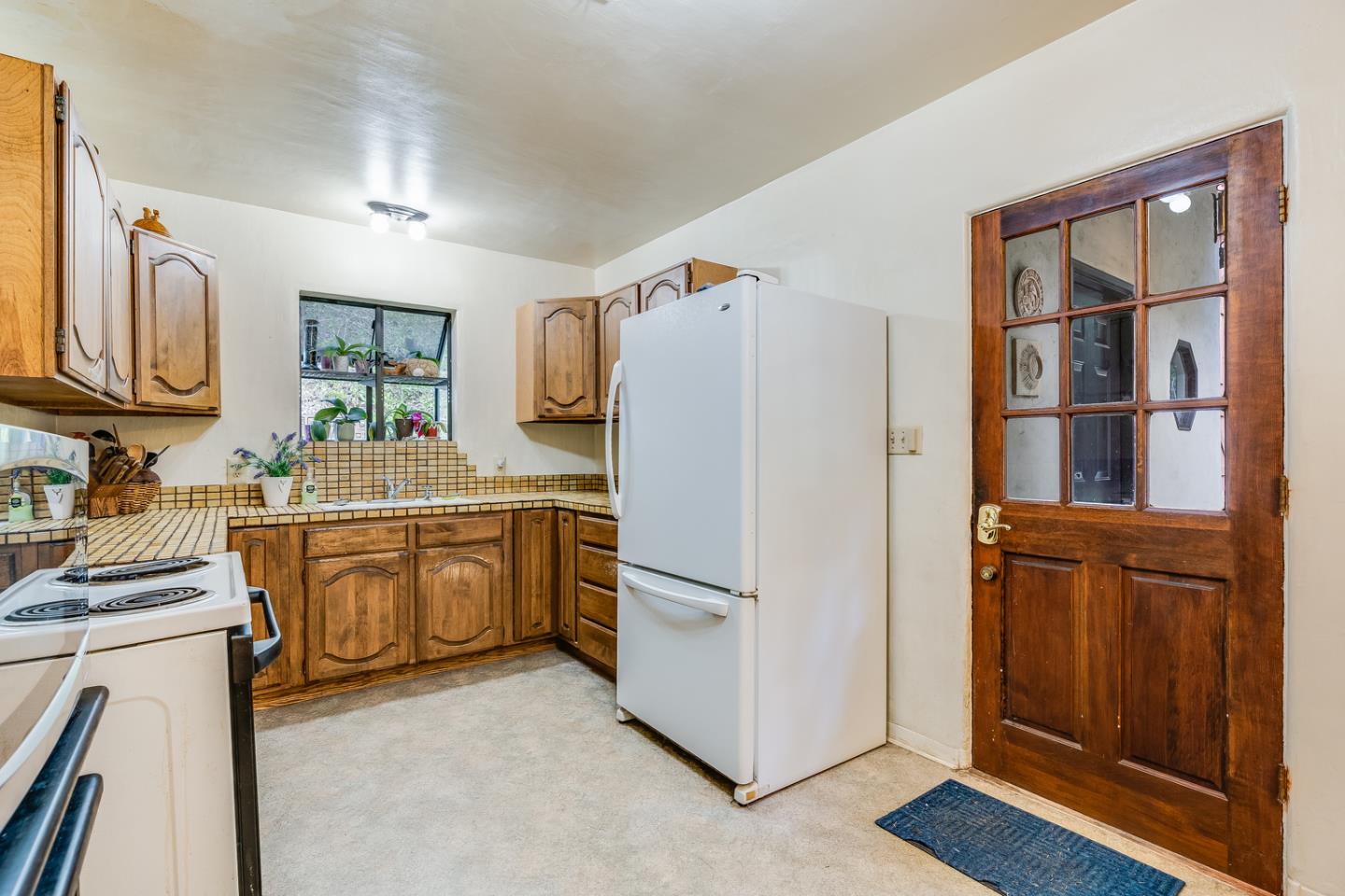 22200 Aldercroft Heights Road Los Gatos, CA 95033 - Photo 11 of 45 a kitchen with a refrigerator stove and sink