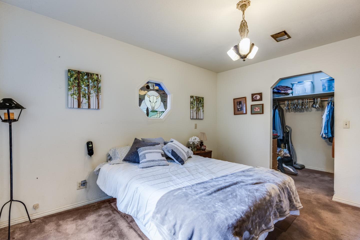 22200 Aldercroft Heights Road Los Gatos, CA 95033 - Photo 13 of 45 a bedroom with bed and a chandelier
