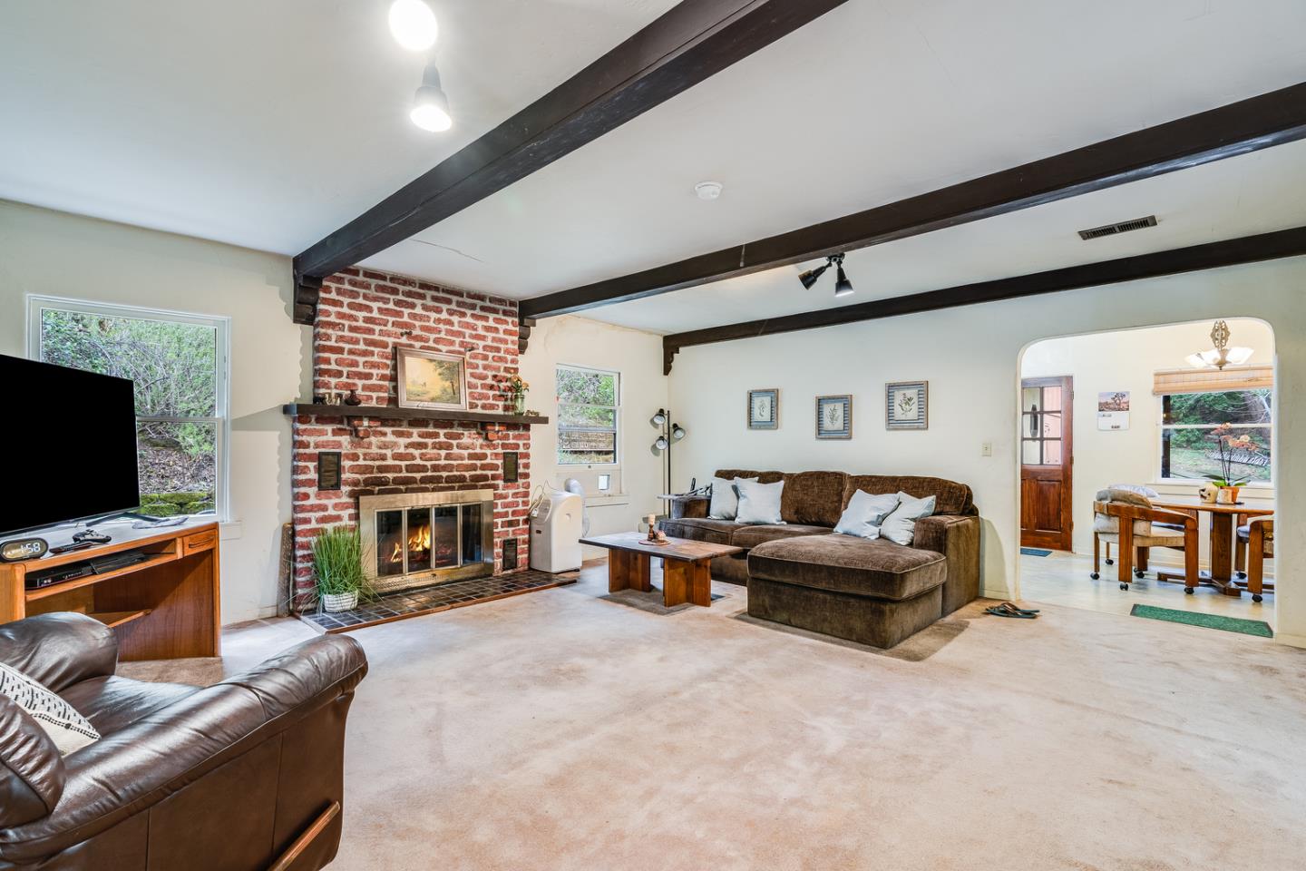 22200 Aldercroft Heights Road Los Gatos, CA 95033 - Photo 8 of 45 a living room with furniture a fireplace and a flat screen tv