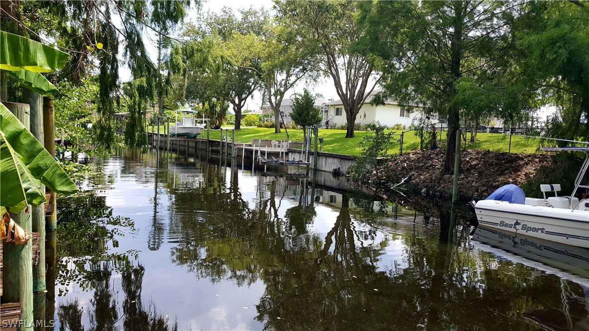 2160 Gardner Road Alva, FL 33920 - Photo 19 of 21 a backyard of a house with lots of green space and lake view