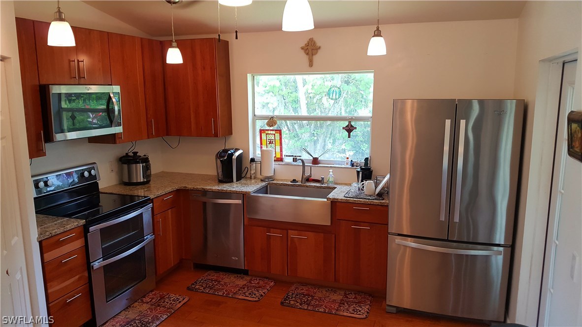 2160 Gardner Road Alva, FL 33920 - Photo 7 of 21 a kitchen with stainless steel appliances a refrigerator sink and cabinets