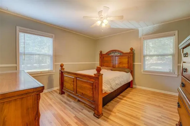 a bedroom with a bed and a window with view of chandelier