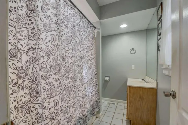 a bathroom with a shower and a sink