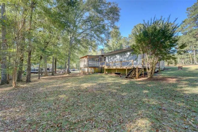 a view of a house with yard and a tree