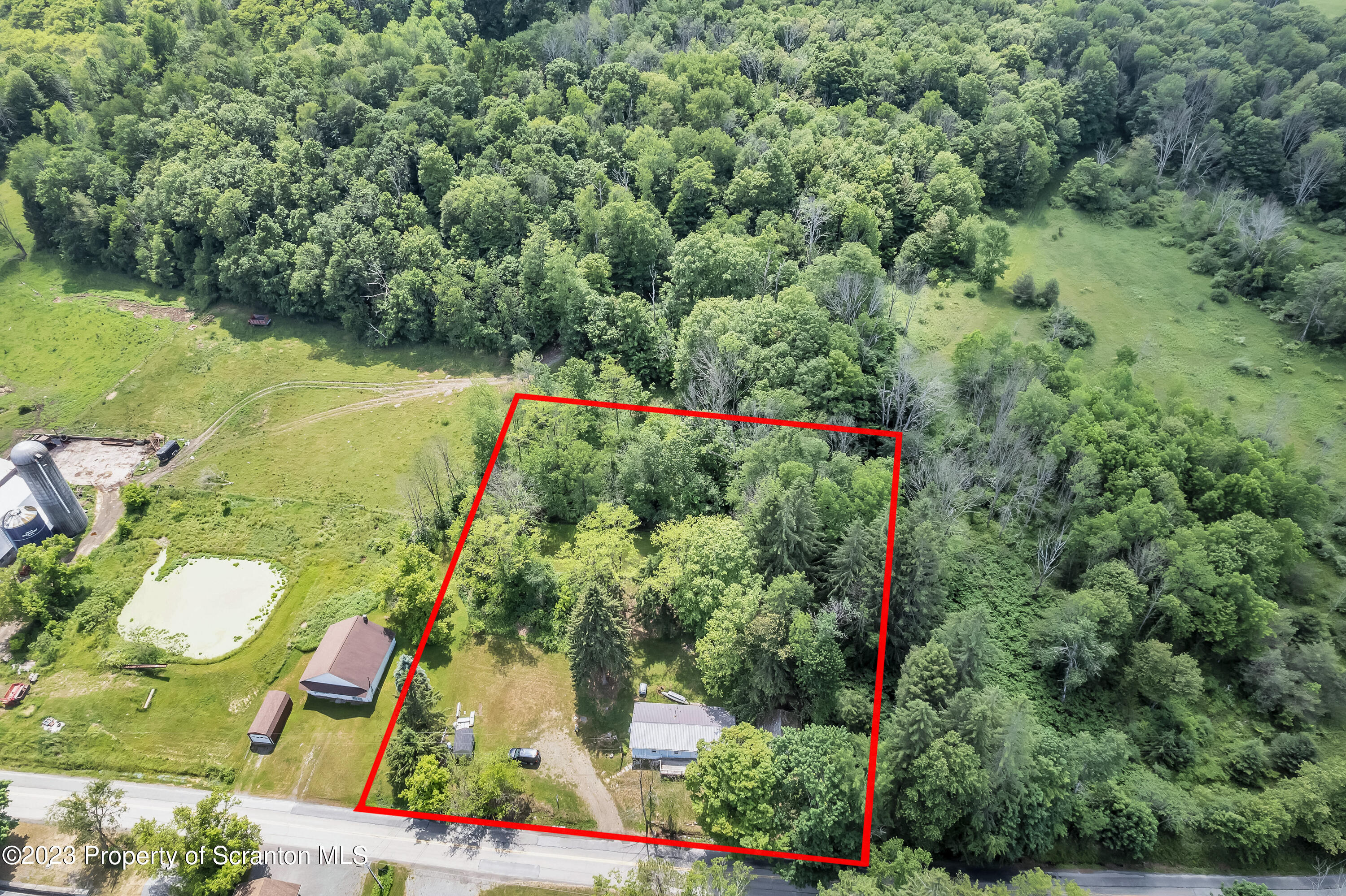 11715 Forest Lake Road Montrose, PA 18801 - Photo 11 of 40 an aerial view of a house with a yard and lake view