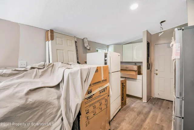 a kitchen with stainless steel appliances a refrigerator and a stove