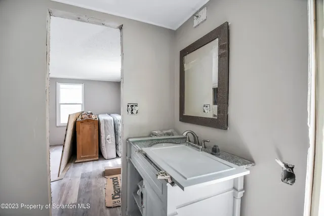 a bathroom with a sink vanity and mirror
