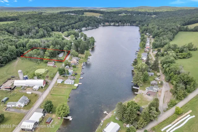 an aerial view of a house with a yard