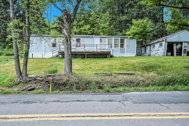 a view of a house with a backyard