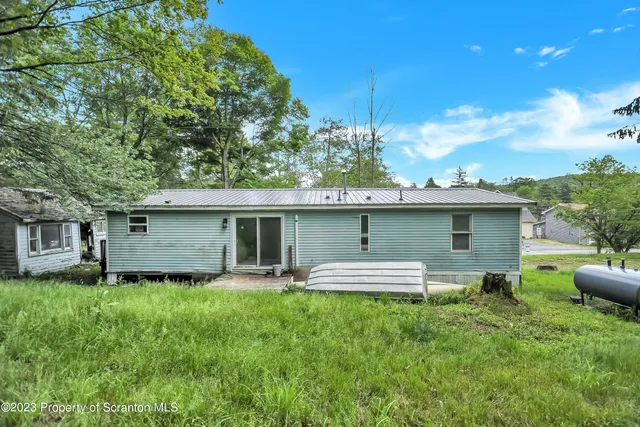a front view of a house with a garden and yard